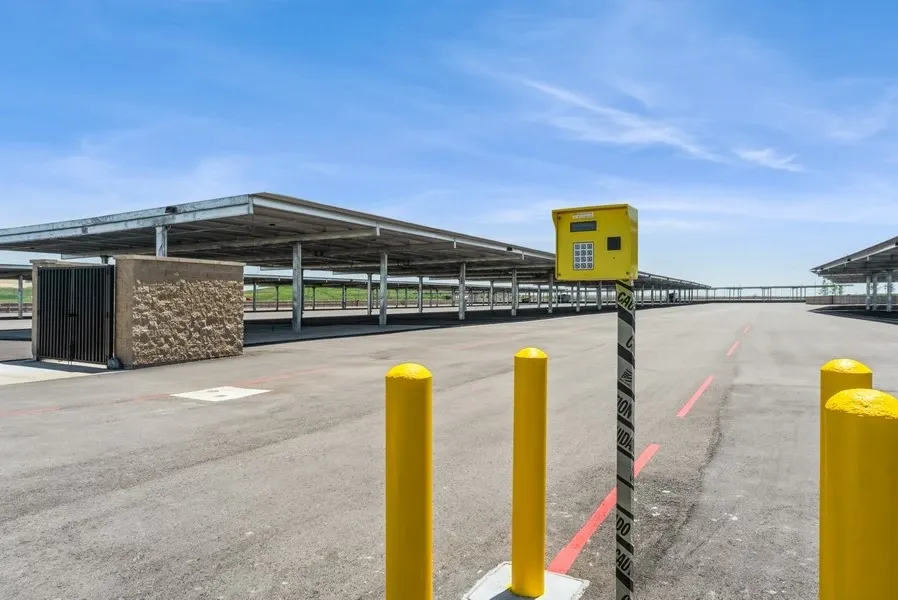 Empty lot of covered parking space with a yellow security box in the foreground
