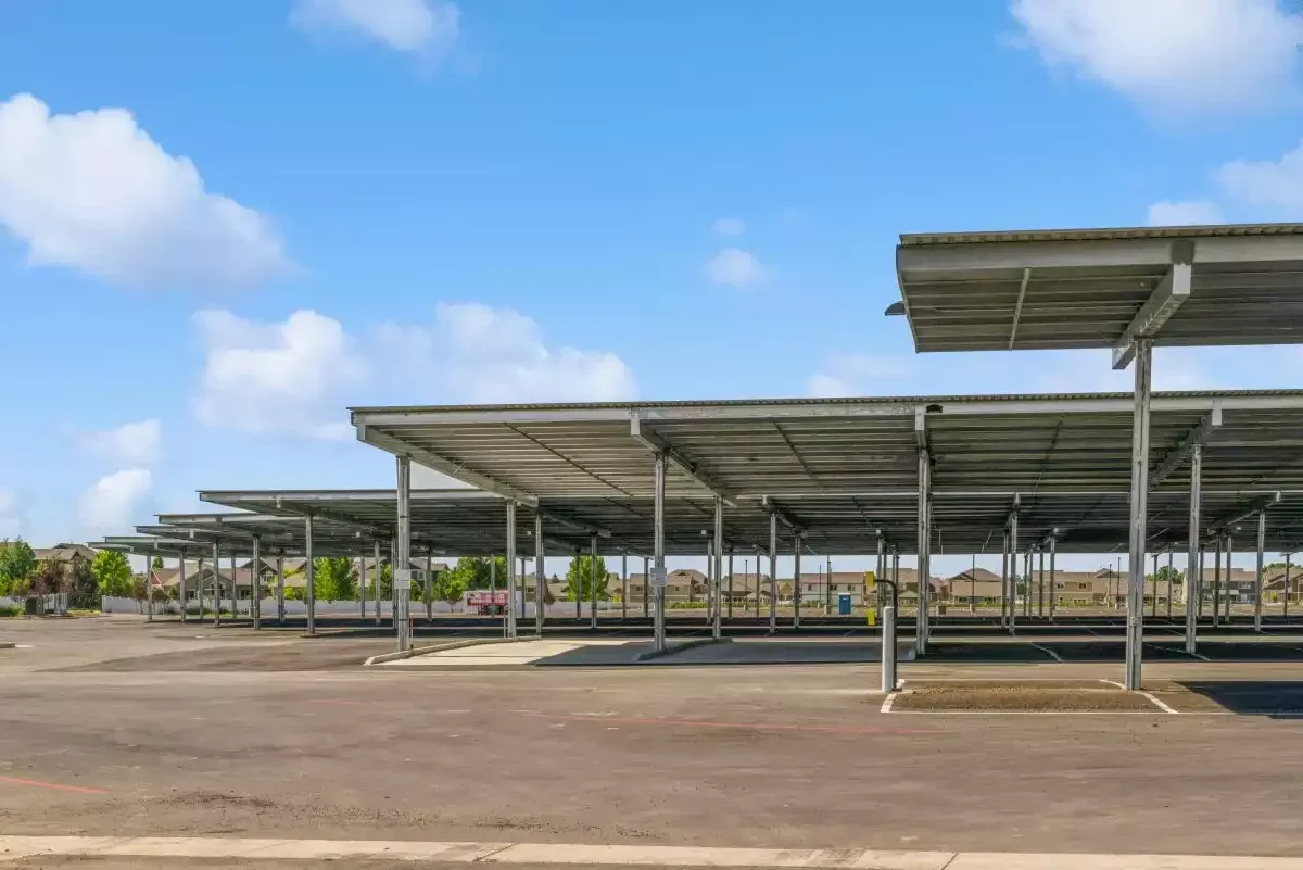 Covered parking spaces on paved ground.