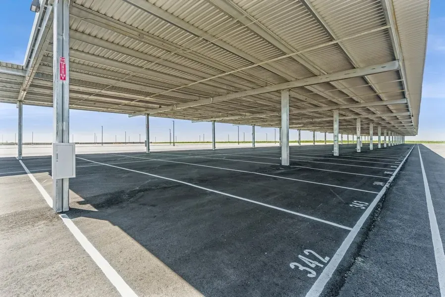 A close up shot of empty covered parking spaces. The space number "342" can been seen.
