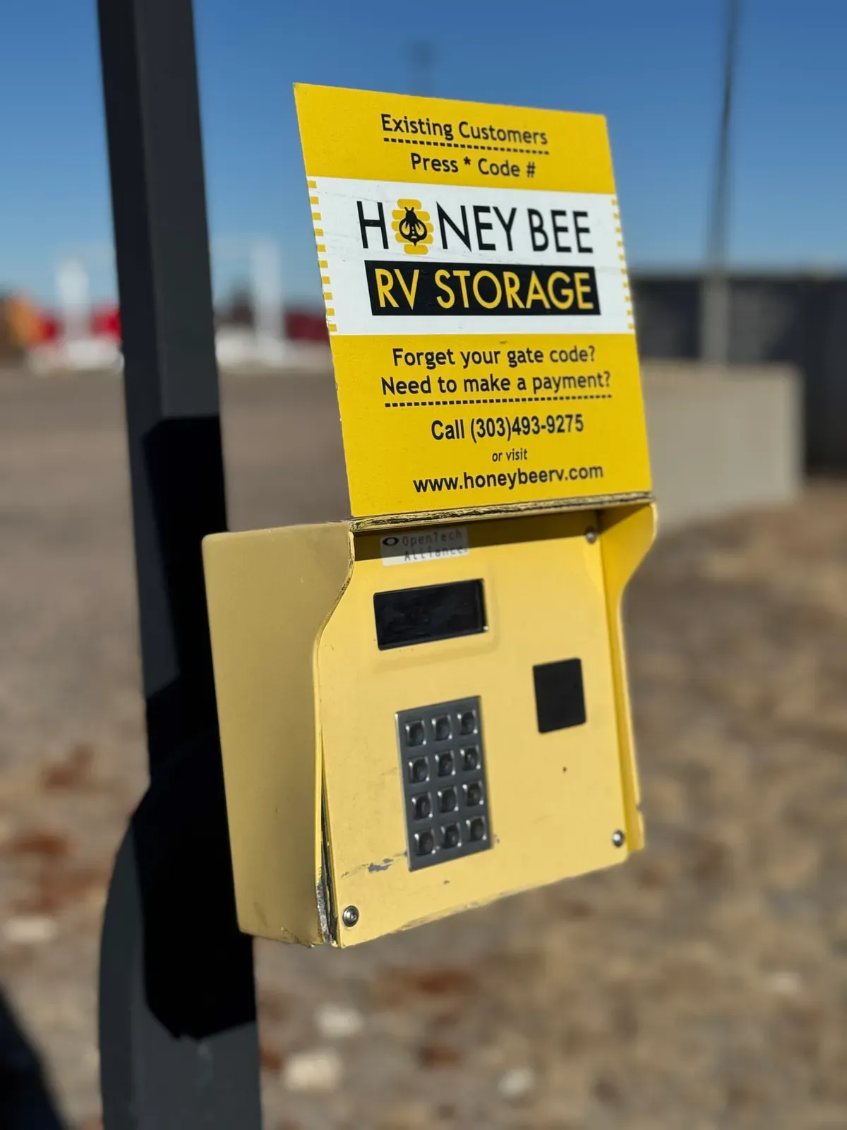 A yellow security box. The Honey Bee RV Storage logo and instructions can be seen.