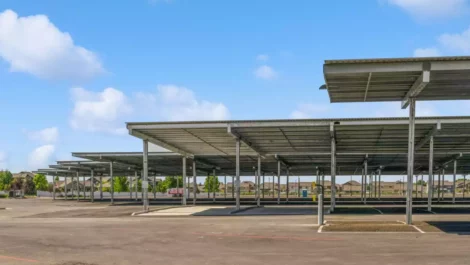 Covered parking spaces on paved ground.