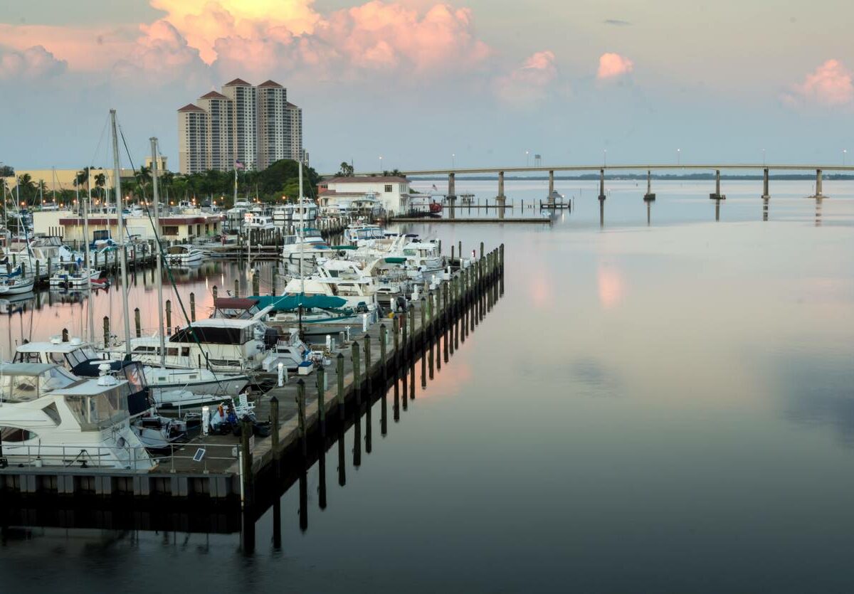 iew of boat dock and highway bridge in downtown Fort Myers, Florida.