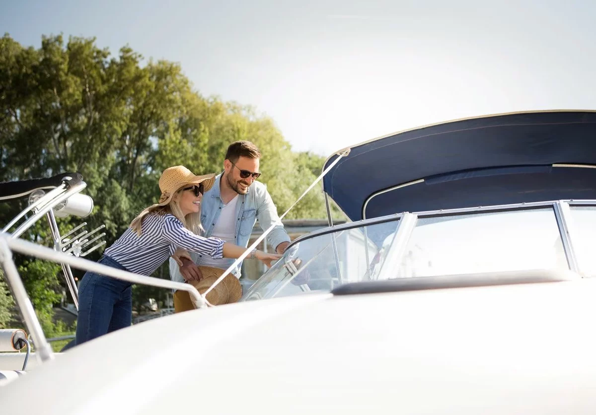 A couple inspecting their boat together.