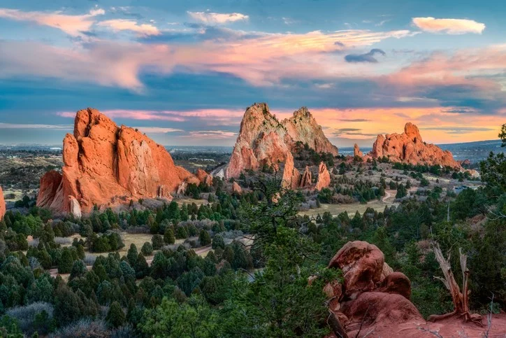 A landscape view of the Garden of the Gods in Colorado Springs, CO, at sunset. 