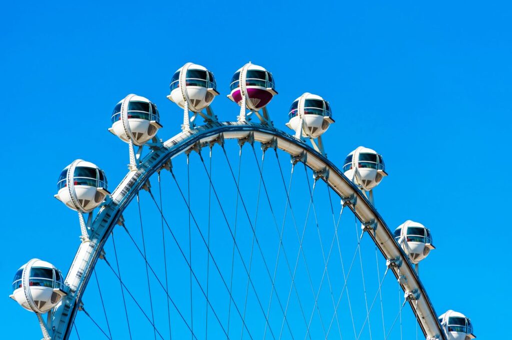 The High Roller Observation Wheel in Las Vegas featuring spacious cabins against a bright blue sky.