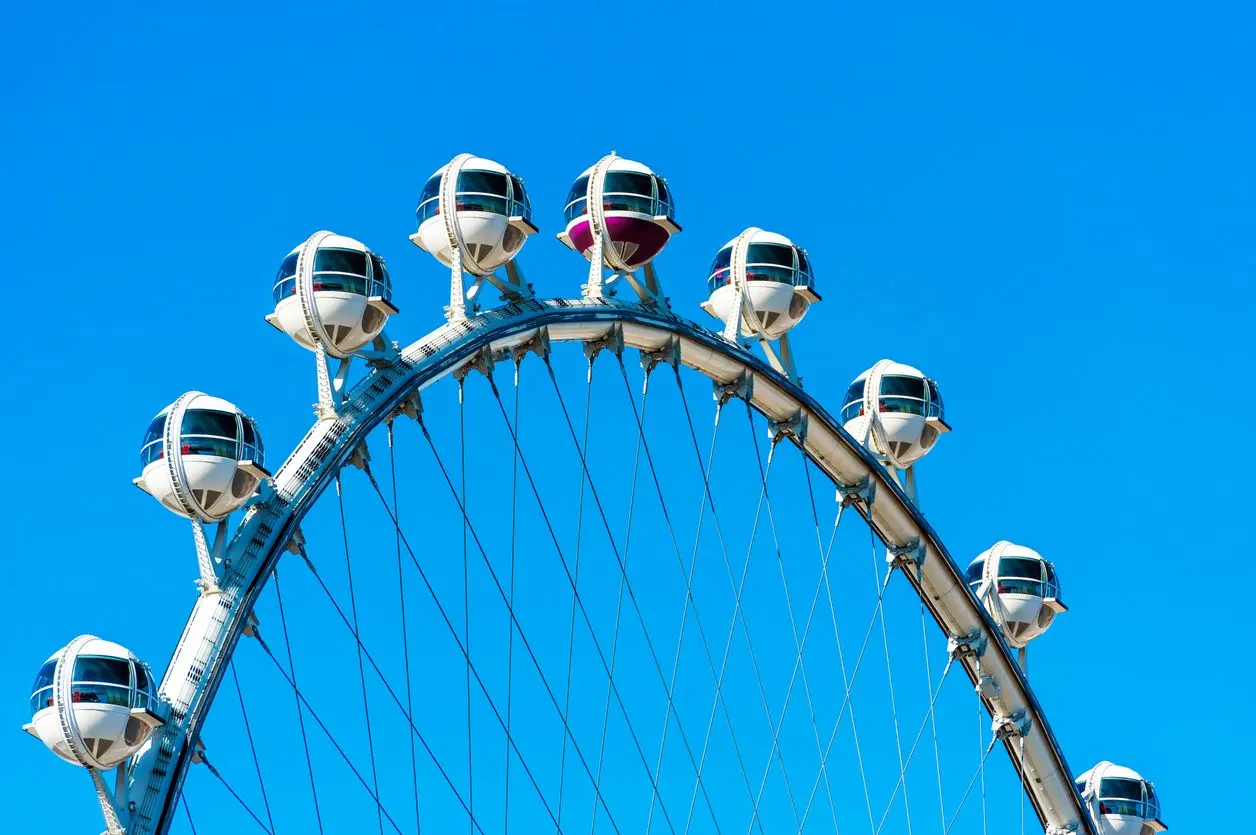 The High Roller Observation Wheel in Las Vegas featuring spacious cabins against a bright blue sky.