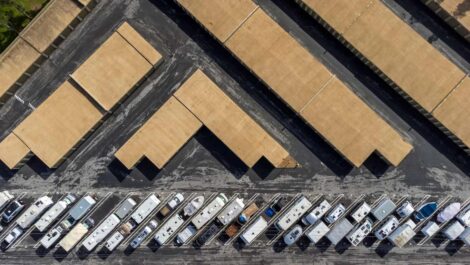 Covered and uncovered RV storage spaces with multiple recreational vehicles parked in organized rows.