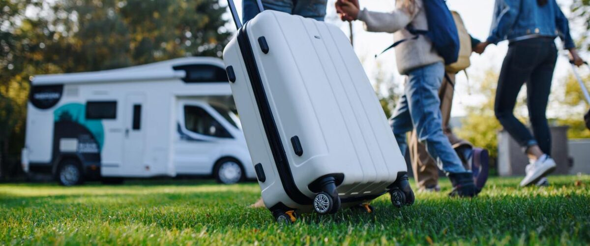 A young family with luggage preparing for an RV road trip.